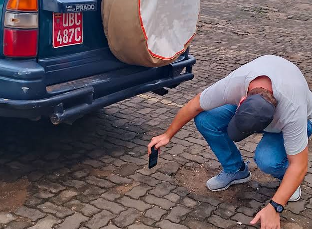 a traveler inspecting a car before moving