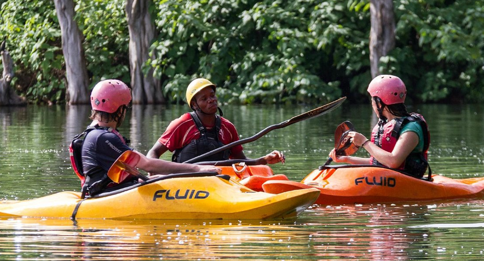 kayakers peddling calm nile waters in jinja