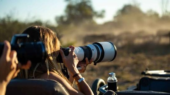 a tourist taking a shoot during a safari in Africa