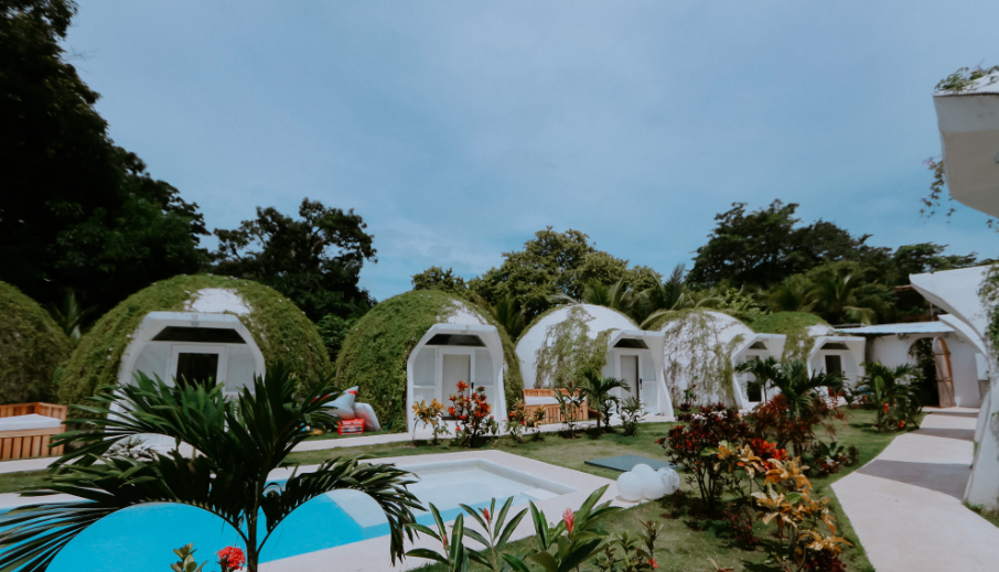 bright open air lounge with couches, books and coffee tables where solo travelers meeet other guests