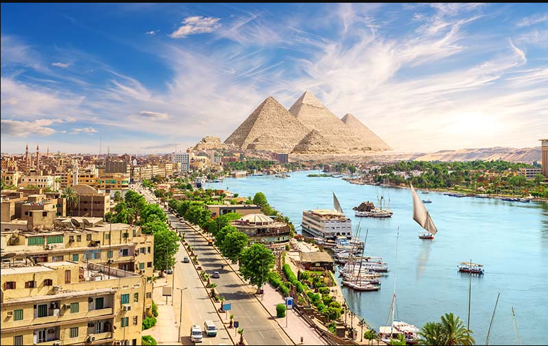 Visiting the Pyramids of Giza in Egypt with the Great Pyramid and Sphinx at sunrise