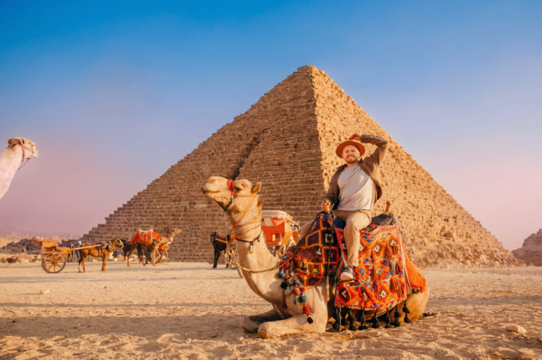 Egypt Tour Packages featuring the Pyramids of Giza, the Sphinx, and camel rides at sunset