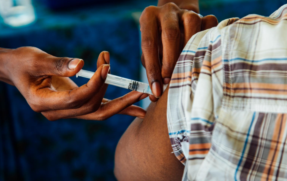 a vacine being administered to atraveler before they travel
