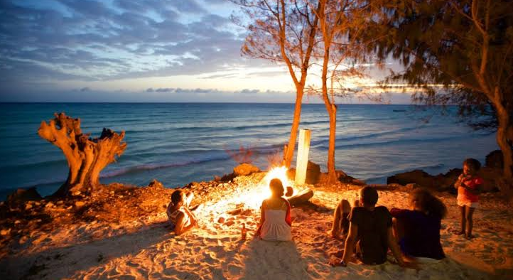 sitting around afire place at the beach