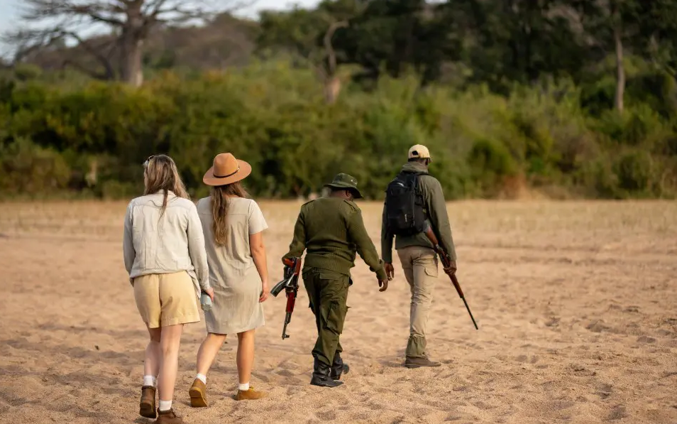 leading travelers putting light clothes on an african safari